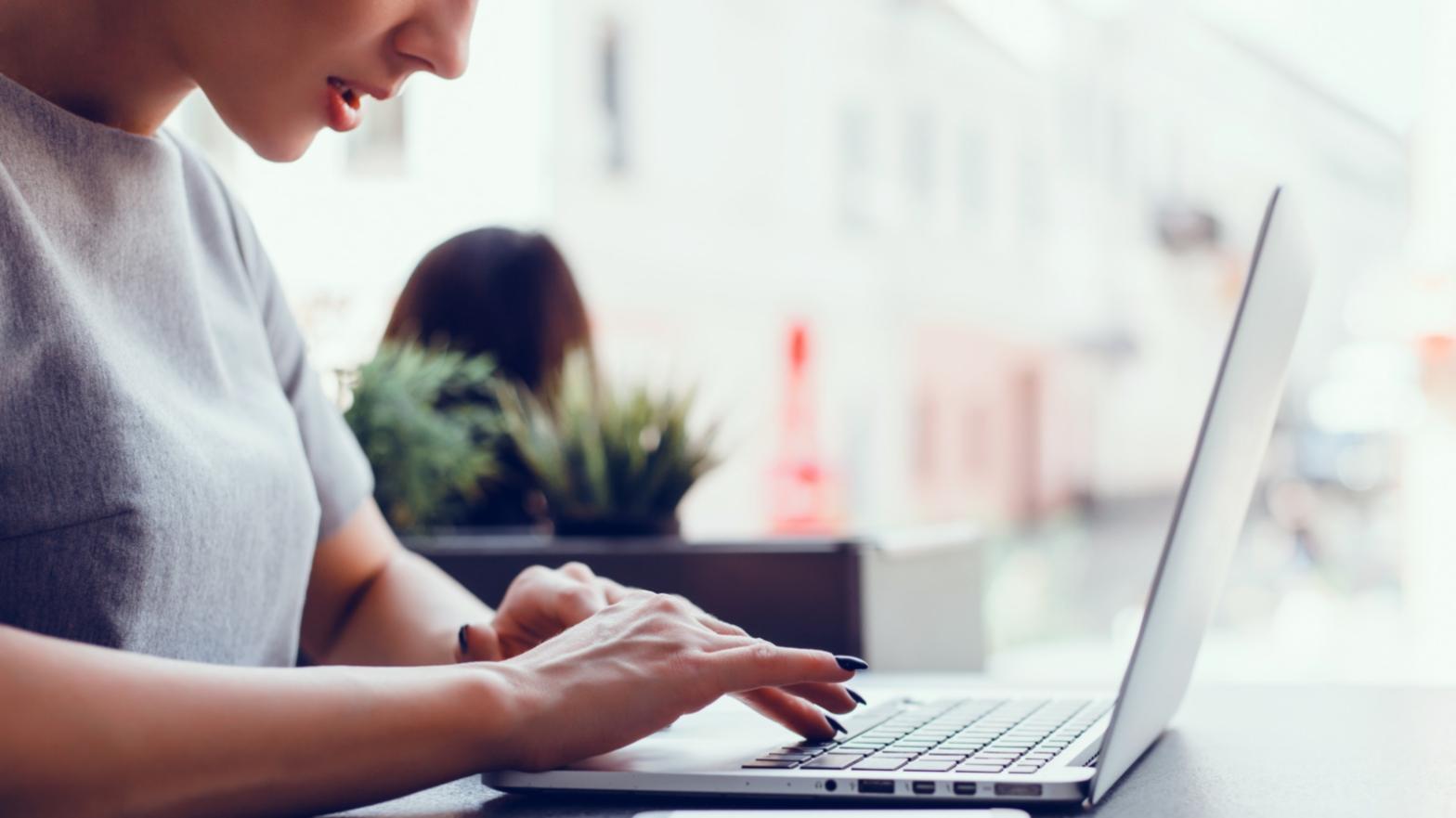 Writer at desk working on novel manuscript